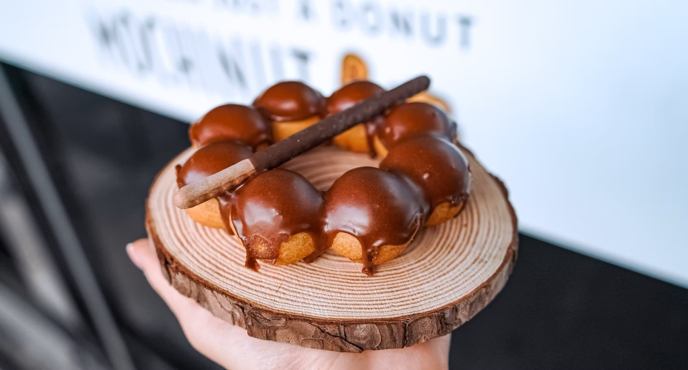 Freshly glazed mochi donut on wooden plate